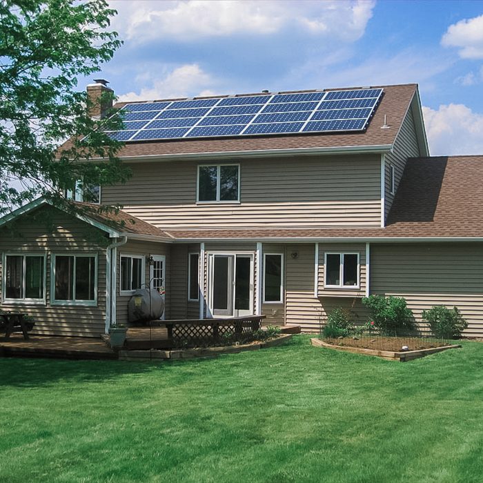 Close-up of residential solar panels with a clear blue sky - Home Solar Panel Installation