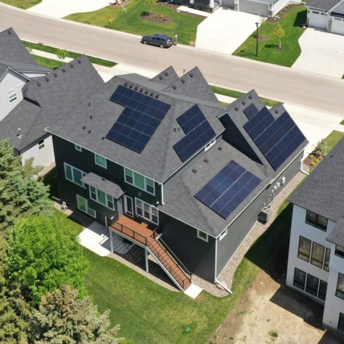 Aerial view of a solar installation surrounded by trees - Solar Panels For Homes