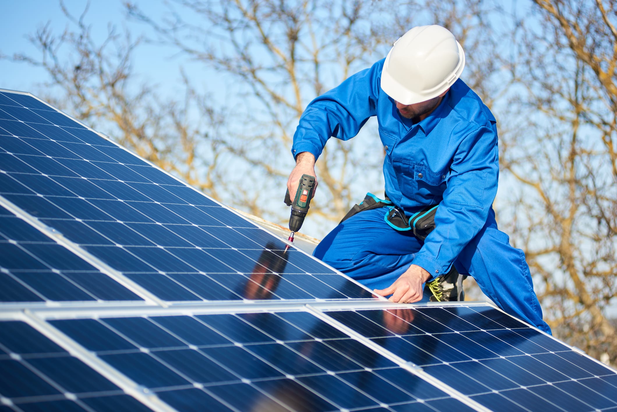 is your roof solar ready? technician installing solar panels on a roof