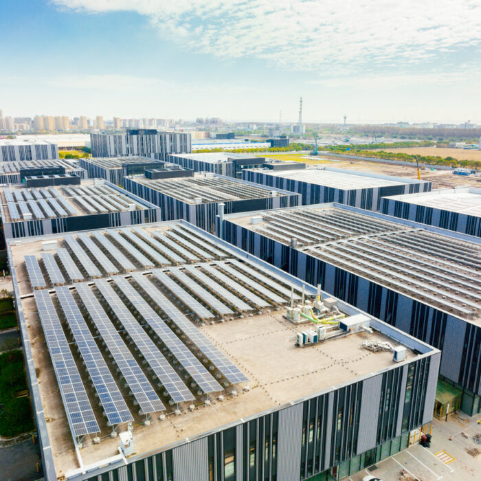 an aerial view of a large building with lots of solar panels - Cedar Creek Energy