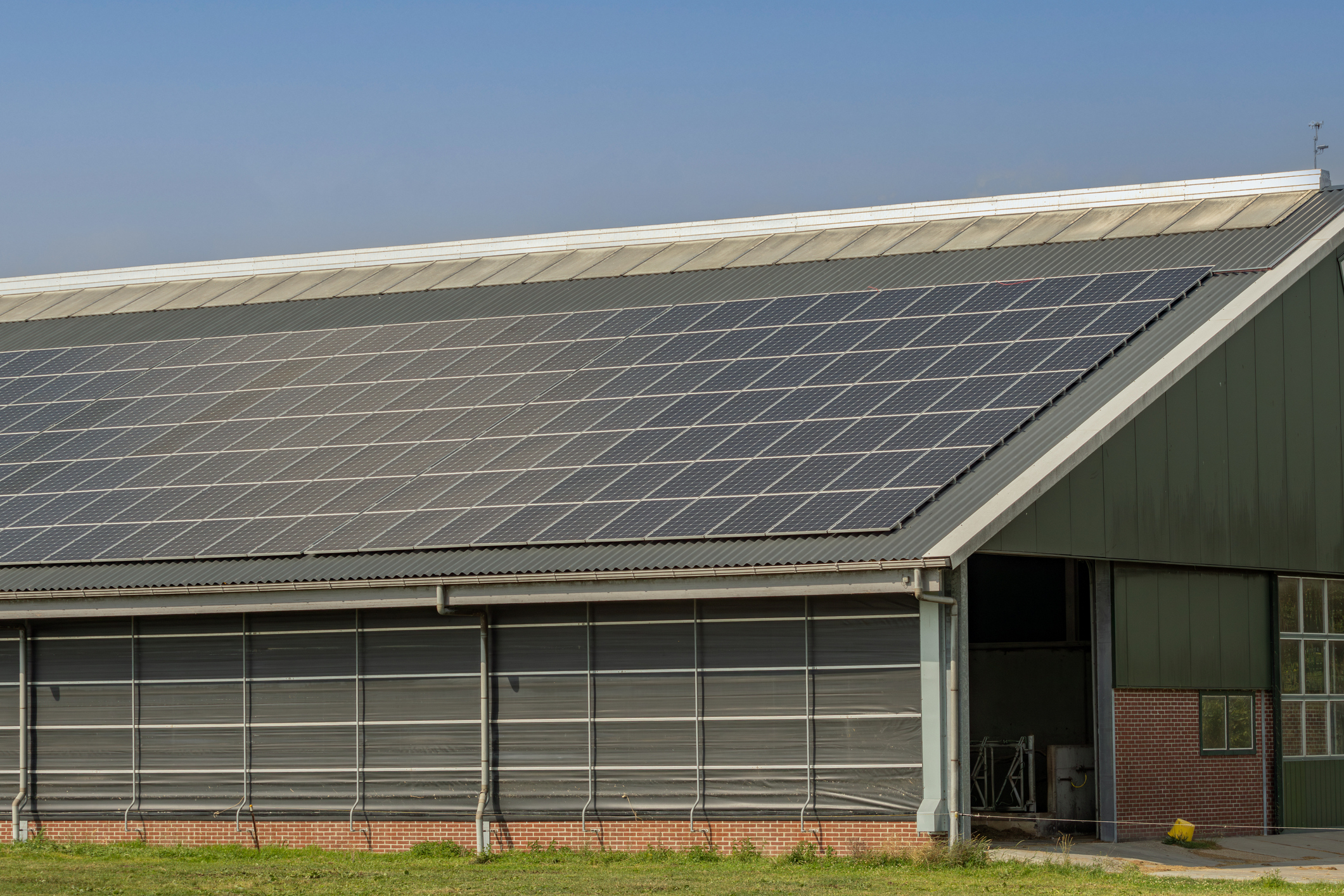 a building with a lot of solar panels on top of it - Solar Panels for Farms and Agriculture Minnesota