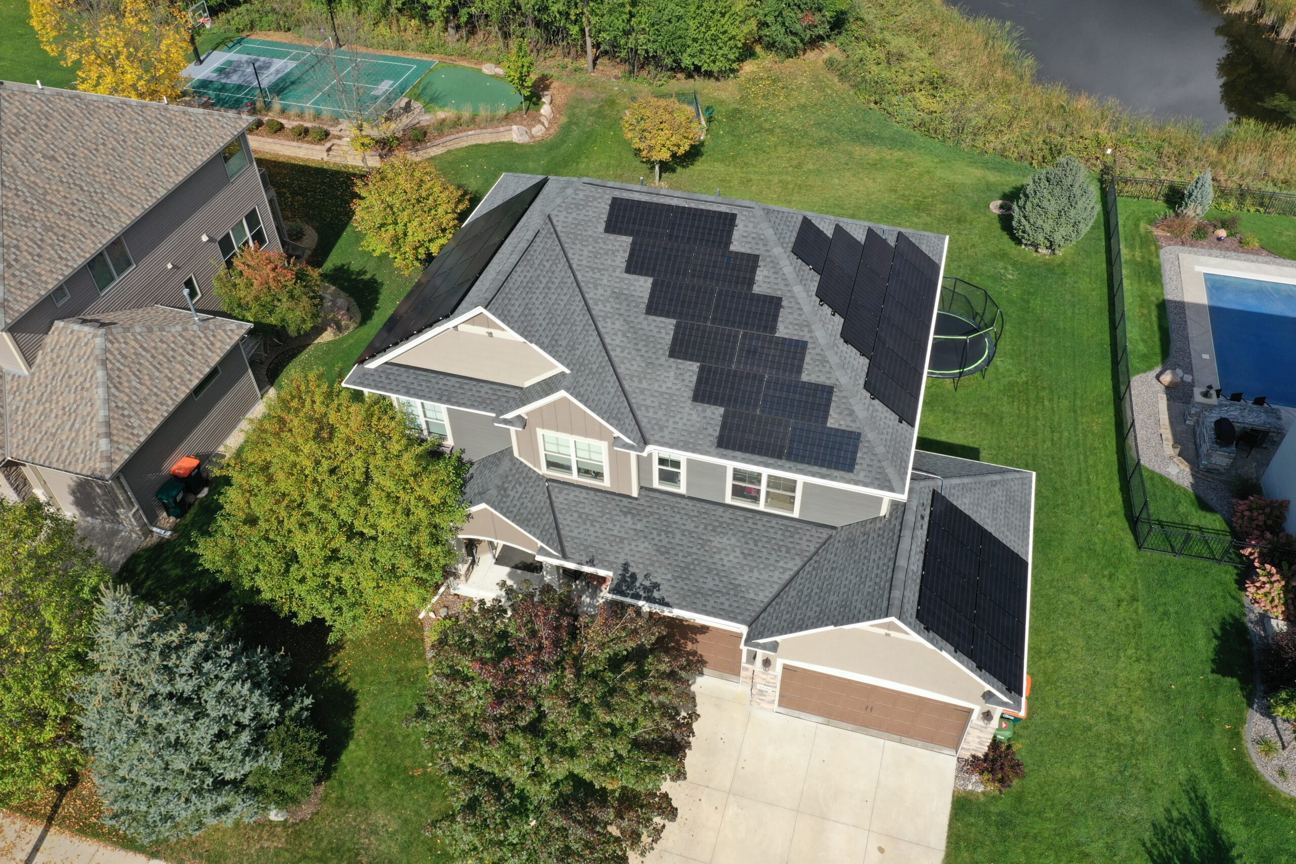 an aerial view of a house with solar panels on the roof -  Home Solar Installers MN