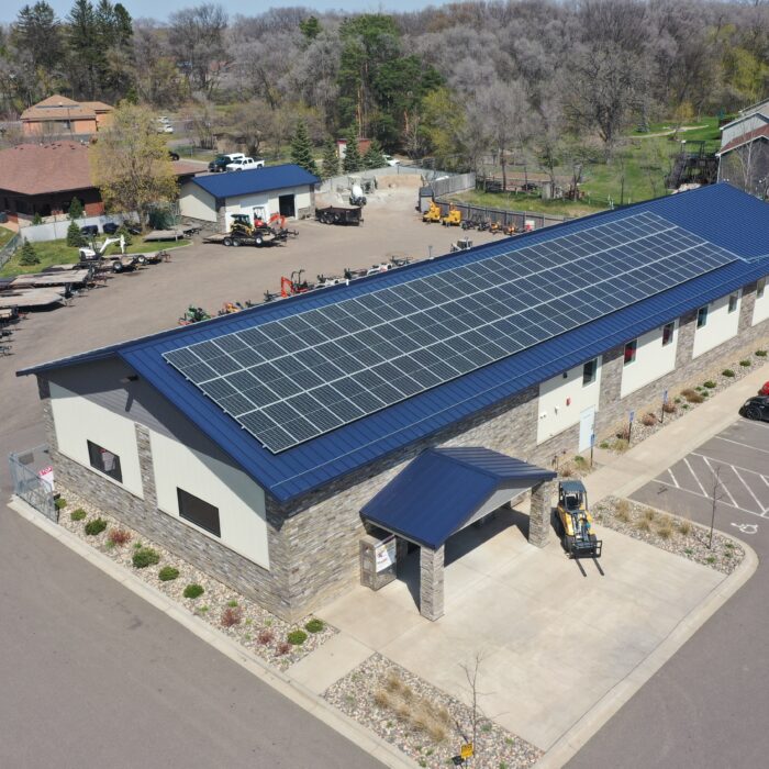 an aerial view of a parking lot with a solar panel on the roof - Solar Energy