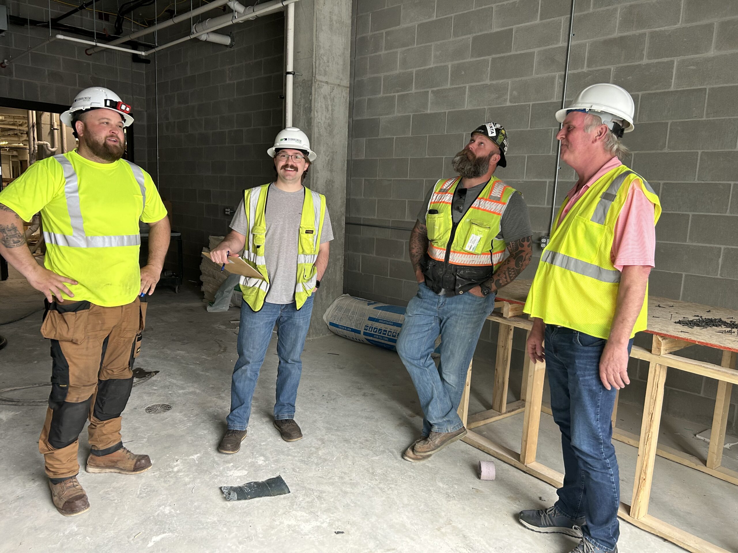 a group of men standing next to each other - Cedar Creek Energy