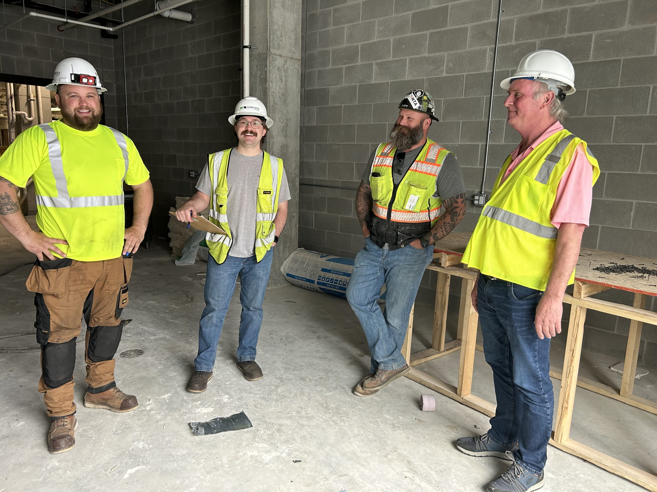 a group of men standing next to each other - Cedar Creek Energy