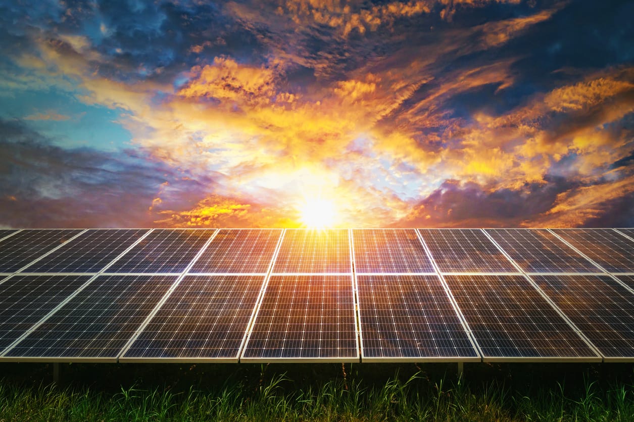 a solar panel with the sun shining through the clouds - Solar Energy